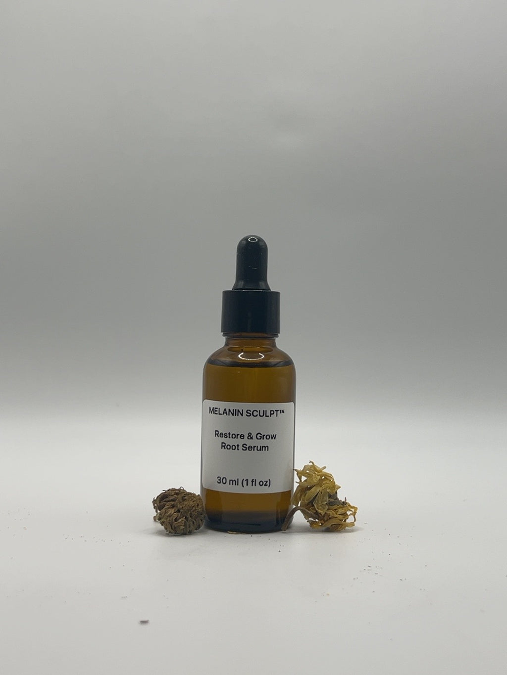 Restore & Grow Root Serum 1 fl oz bottle with dried botanicals