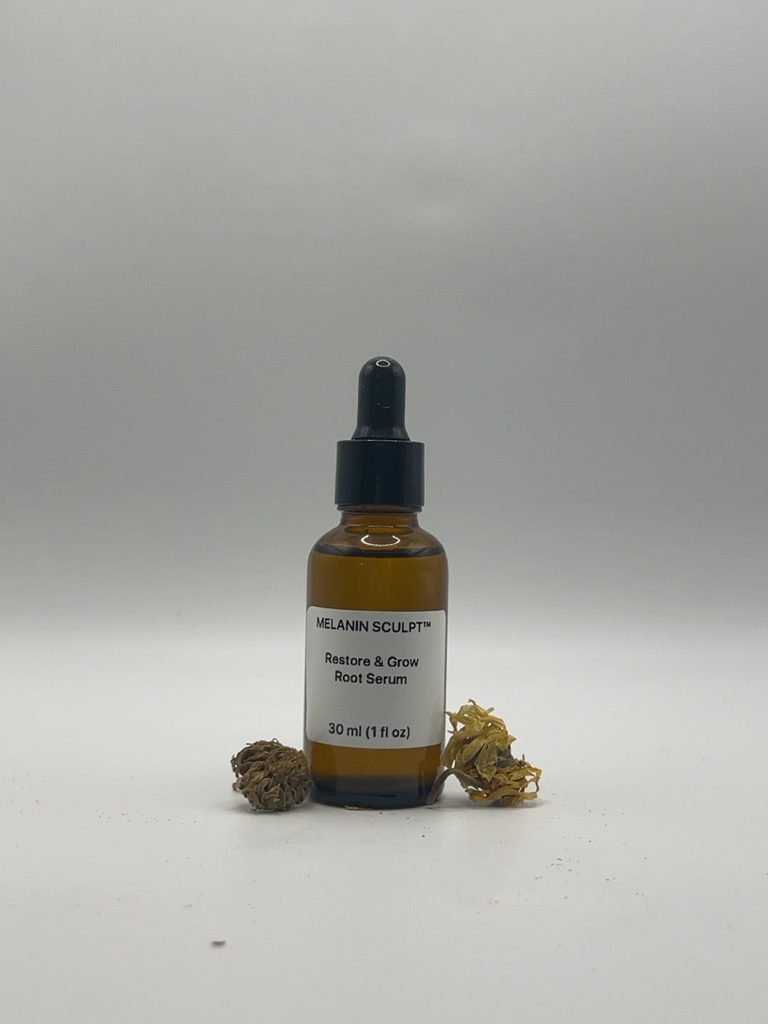 Restore & Grow Root Serum 1 fl oz bottle with dried botanicals