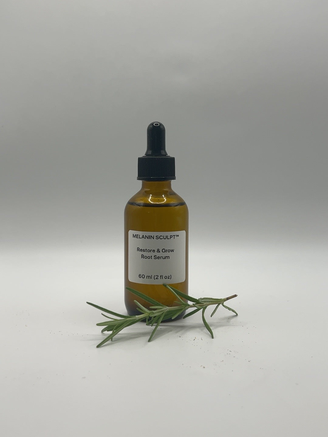 Restore & Grow Root Serum 2 fl oz bottle with rosemary